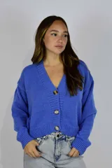 Cardigan de punto azul con escote en V, cierre frontal de botones y mangas largas holgadas.