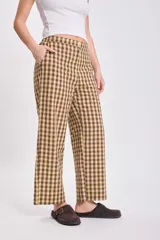 Pantalón de corte recto y tiro medio con estampado de cuadros vichy en tonos verde y beige. Cuenta con bolsillos laterales y cierre frontal.