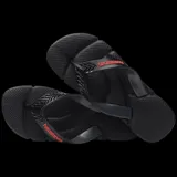Sandalias tipo ojotas Havaianas modelo Power 2.0, color negro con detalles en rojo. Presentan una suela texturizada con diseño ergonómico y tiras anchas con relieve.