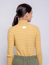 Polera amarilla con cuello alto y diseño a rayas horizontales.