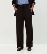 Pantalón de corte recto y calce suelto, confeccionado en tejido de viscosa, poliéster y elastano. Presenta cintura elástica con cordón ajustable con punteras metálicas, recortes frontales y bolsillos traseros.