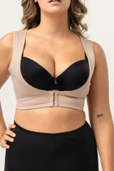 Top corrector de postura color piel, de alta tensión con bandas cruzadas en la espalda y broche delantero en bajo busto. Confeccionado con tela que contiene fibra LYCRA®.