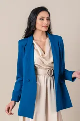 Blazer azul eléctrico de crepe y spandex, corte clásico, con solapas de muesca, cierre cruzado con botones forrados y bolsillos con solapa.