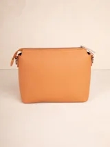 Bandolera color beige de cuero sintético texturizado, con correa desmontable y regulable. Tiene un compartimento principal con cierre y tres bolsillos internos adicionales.
