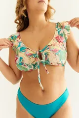 Top de bikini con estampado floral, volados en los hombros y nudo regulable en el escote.