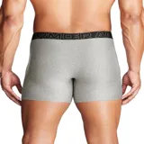 Pack de tres boxers Under Armour en colores negro, gris oscuro melange y gris claro melange, con cintura elástica ancha con el logo de la marca.