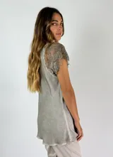 Blusa blanca de viscosa con escote en V y mangas cortas de encaje floral.