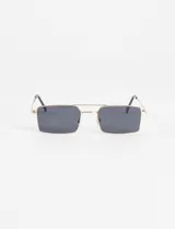 Lentes de sol con montura metálica dorada y cristales rectangulares color marrón. Presentan un puente doble característico del estilo aviador modificado.