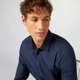 Camisa de vestir azul marino con lunares blancos, de corte clásico y manga larga.