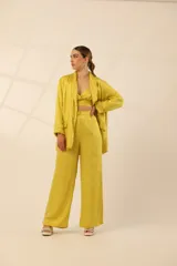 Blazer verde esmeralda de seda con solapas y botón blanco.