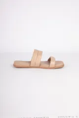 Sandalias bajas color beige con dos tiras acolchadas.