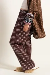 Pantalón de pijama marrón chocolate con lunares blancos.