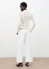 Top de tejido de punto calado con cuello perkins y manga larga, de diseño entallado.