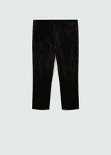 Leggings capri de corte skinny, confeccionados en tejido cubierto de lentejuelas negras. Presentan una cintura con elástico para un ajuste cómodo y un diseño sin cierre.