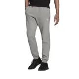 Pantalón de jogging gris con cintura elástica y logo de Adidas bordado en blanco en la pierna izquierda.