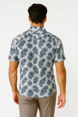 Camisa de manga corta con cuello tipo cubano, confeccionada en viscosa con estampado de hojas en tonos azul y blanco.