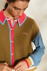 Cardigan de punto con diseño tricolor, de corte relajado, manga larga de tejido trenzado en contraste de color, cuello solapa tipo polo y cierre frontal de botones.