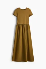 Vestido maxi marrón con cuerpo entallado de punto interlock pesado, cuello redondo, mangas cortas, cintura fruncida y falda larga de gran volumen en tejido liviano de algodón.