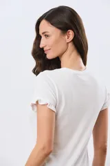 Remera de algodón color verde menta, con escote redondo y mangas corta con detalles de volados sutiles en los puños.