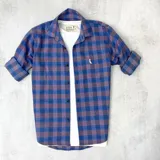 Camisa de algodón a cuadros azules y bordó, de manga larga con puños abotonados.