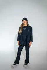 Calza deportiva de tiro alto con corte oxford, confeccionada en poliamida y elastano. Presenta un diseño ajustado en la parte superior y ligeramente acampanado en los tobillos con aberturas laterales.
