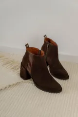 Botinetas de cuero color marrón, con diseño de caña baja, taco cuadrado y cierre lateral.