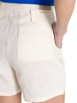 Short estilo cargo tiro alto de lino orgánico color beige, con pinzas frontales, amplios bolsillos laterales con solapa y botones, y trabillas para cinturón.