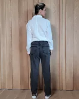 Pantalón de jean de corte recto y tiro medio, en color gris oscuro con efecto lavado. Presenta cierre frontal con botón y bolsillos laterales y traseros.