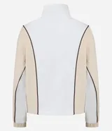 Campera deportiva de cuello alto con cierre frontal completo. Presenta un diseño bicolor en blanco y beige con líneas curvas en negro que definen la silueta. Confeccionada en una mezcla de poliéster, modal y elastano.