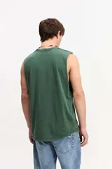Musculosa oversize de algodón color marrón con efecto lavado desgastado, de corte amplio y sin mangas. Cuenta con una estampa frontal en relieve y diseño urbano de la marca Mistral.