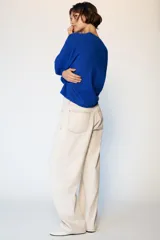 Jeans de tiro medio con diseño barrel, corte holgado que se estrecha hacia el tobillo y cinco bolsillos. Presenta costuras a contraste y cierre frontal con cremallera y botón.