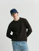 Sweater de punto con escote redondo, confeccionado en algodón con textura de punto fantasía en cuerpo y mangas, y terminaciones en punto canalé en cuello y puños.