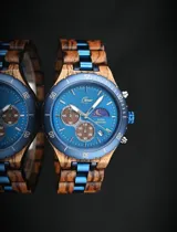Reloj de pulsera Chenaut modelo Ocean, con caja y malla combinadas en madera de Zebrano africano y acero inoxidable azul. Presenta una esfera azul con subdiales de madera, indicador de fase lunar, fechador y bisel técnico tipo buzo.