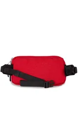 Riñonera JanSport Washington Waistpack, color azul con detalles en rojo y negro. Logo de la marca estampado en el frente.