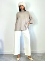 Poleron de punto color beige, con cuello alto y mangas tres cuartos con puños acanalados. Diseño holgado y oversized.