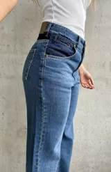 Pantalón de jean de tiro alto, color azul con detalles en azul oscuro en los bolsillos delanteros.