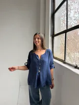 Blusa azul marino de lino, con escote en V y botones frontales de madera.