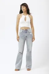 Top corto de tejido acanalado color blanco, con cuello halter y abertura frontal tipo gota, con diseño cruzado en la cintura.