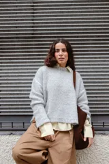Buzo tejido en mohair de corte crop, con cuello redondo y tajos laterales. Diseño holgado con mangas largas.