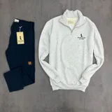 Buzo gris claro melange de algodón con felpa, cuello alto con medio cierre y logo Duxon Jeans bordado en el pecho.