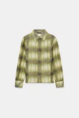 Camisa de manga larga con cuello solapa y cierre frontal de botones. Presenta un estampado de cuadros en tonos verdes, amarillos y grises, con un efecto ligeramente desvanecido o transparente.