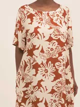 Vestido largo camisero de seda viscosa con estampado de flores y tigres en tonos naranja y blanco. Cuenta con botones nacarados, bolsillos, lazo para la cintura y aberturas laterales.