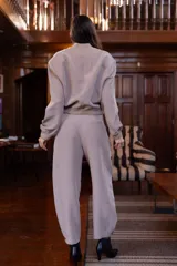 Pantalón color visón de corte ancho, con pinzas y bolsillos laterales.