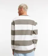 Buzo de algodón y poliéster con cuello redondo y mangas largas. Diseño a rayas horizontales en color blanco y gris. Puños y bajo acanalados.