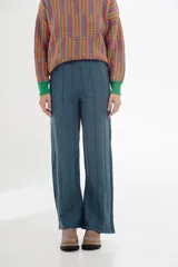 Pantalón tejido azul con corte acampanado y textura acanalada vertical.