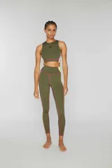 Crop top deportivo verde oliva sin mangas de lycra con banda lateral color block en amarillo y rosa y pespuntes overlock en contraste. Estampado de logotipo en la parte delantera.