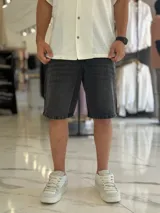 Bermuda de jean de corte oversize, en color negro con efecto gastado.