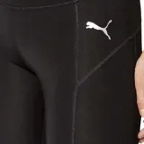 Calza deportiva Puma de mujer, color negro, corte capri, con cintura alta y logo reflectivo en la pierna izquierda.