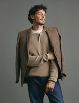 Remera de punto tipo polo con textura waffle, color verde petróleo, de manga larga y cuello con cierre de botones.