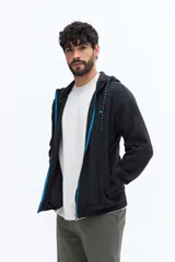 Campera con cierre de algodón y poliéster, color azul marino, con capucha ajustable mediante cordones trenzados en blanco y azul. Presenta un pequeño logo bordado en el pecho y bolsillos laterales.